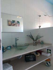 a bathroom with a glass sink on a counter at Refúgio da Serra - Cottage House in Fornos de Algodres +68 photos