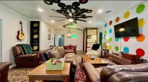 un soggiorno con mobili in pelle e una TV a schermo piatto di The Venue a Lubbock