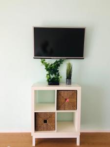 a white table with a tv on top at Refúgio da Serra - Cottage House in Fornos de Algodres