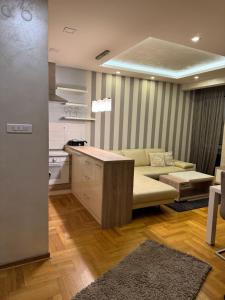 a living room with a couch and a table at Vila Ljubovic in Podgorica