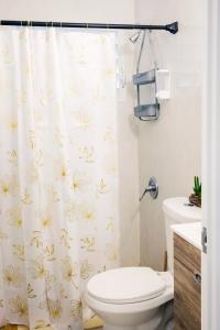 a bathroom with a toilet and a shower curtain at Alojamiento completo familiar in Carolina +27 photos