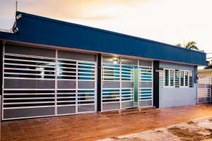 a building with large windows and a blue roof at Alojamiento completo familiar in Carolina