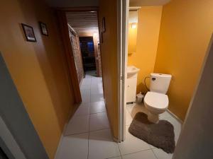 a bathroom with a toilet and yellow walls at Ader puhkemaja in Kogula +21 photos