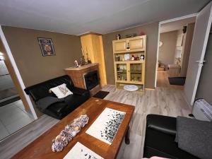 a living room with a table and a fireplace at Ader puhkemaja in Kogula