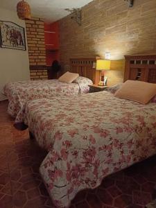 a hotel room with two beds in a room at Hotel Huasca Terrazza in Huasca de Ocampo +13 photos