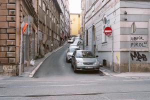 un'auto parcheggiata sul lato di una strada cittadina di SoulNest Apartments a Sarajevo