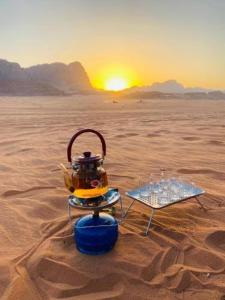 a tea pot on a stand in the desert at Wadi Rum Salem Muhammad in Wadi Rum