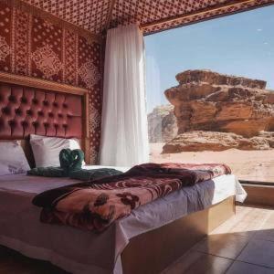 a bedroom with a bed with a teddy bear on it at Wadi Rum Salem Muhammad in Wadi Rum