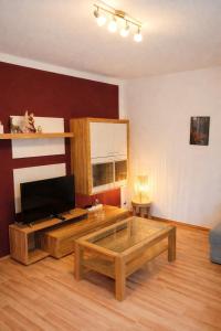 a living room with a couch and a coffee table at Wald & Weg in Schmallenberg