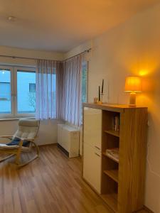 a room with a chair and a desk and a window at Wald & Weg in Schmallenberg