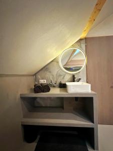 a bathroom vanity with a mirror and a sink at L'annexe 3 - Cosy studio Dole in Foucherans