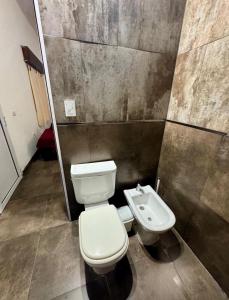a bathroom with a toilet and a sink at Sueños de Mar in Mar del Tuyú