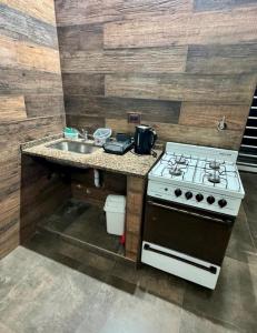 a kitchen with a stove and a sink at Sueños de Mar in Mar del Tuyú