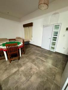 a living room with a table and chairs in a room at Sueños de Mar in Mar del Tuyú