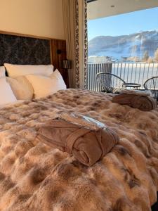 a large bed with a blanket on top of it at Alpen Sky Suite Flachau in Flachau +90 photos