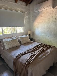 a bedroom with a large bed with a large window at Puerto Sosiego in Gualeguaychú +34 photos