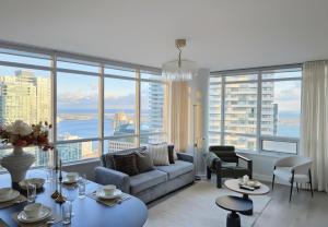 a living room with a couch and a large window at Luxury 40th-Floor Lakeview 2BR with PATH & Union Access in Toronto