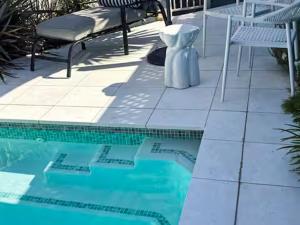 a swimming pool with a table and chairs next to it at Pool Heated Lake Views 1BR Apartment in Coal Point