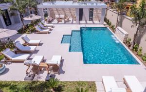 an image of a swimming pool with chaise lounge chairs and a swimming poologgle at Solena Hotel in Camburi