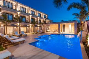 a swimming pool in front of a building at Solena in Camburi