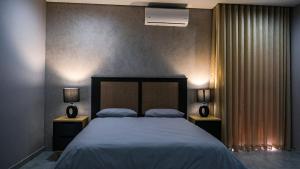 En eller flere senge i et værelse på Mupauli Boutique Lodge