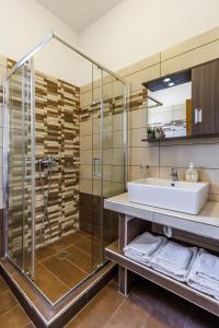 a bathroom with a sink and a shower at Studios Galini in Skopelos Town +92 photos