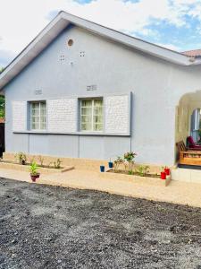a white house with two windows and a driveway at KidotuiVillaHome in Arusha