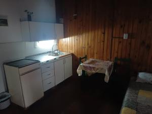 a kitchen with a sink and a table in it at Hostería Don Atilio in Posadas