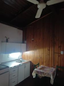 a kitchen with a table and a sink and a ceiling at Hostería Don Atilio in Posadas