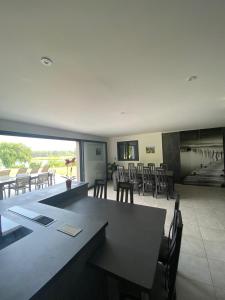 une grande salle à manger avec une table et des chaises dans l'établissement Chambres d'hôtes bord de Saône, à Lamarche-sur-Saône