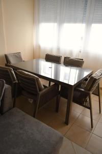 a dining table and chairs in a room with a window at Coastal Calm in Golem