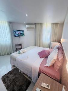 En eller flere senge i et værelse på Vila do Morro Pousada