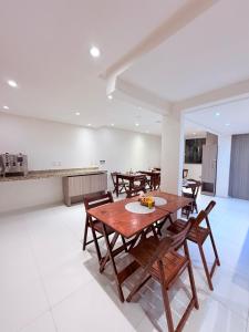 a dining room with wooden tables and chairs at Vila do Morro Pousada in Morro de São Paulo