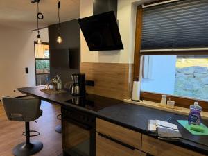 a kitchen with a counter top and a window at woidpanorama 3 Appartement in Neuschönau +6 photos