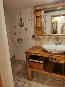 a bathroom with a sink and a mirror at Chalupka u macka in Párnica