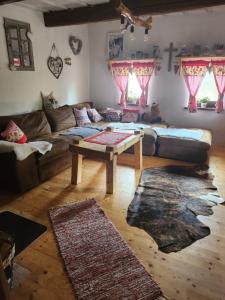 a living room with a couch and a coffee table at Chalupka u macka in Párnica