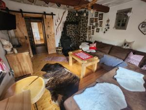a living room with a couch and a table at Chalupka u macka in Párnica