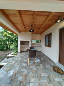 an open patio with a table and chairs on a stone floor at Las Calandrias II in Los Reartes