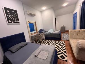 a living room with a couch and a bed and a chair at iBiZa Hostel in Beni Suef