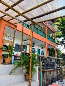 a restaurant with an orange and white building at Vila Pepouze Hostel in Morro de São Paulo