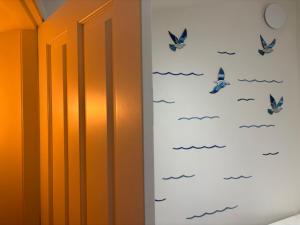 a room with butterflies on the wall at CASINA La RIBERA in Cudillero +11 photos