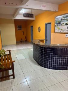 a lobby with a reception counter in a building at Pousada e Hostel Santos in Barreirinhas