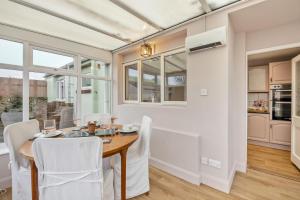 a dining room with a table and white chairs at 2 Bed in Lowick oc-c34008 in Lowick +18 photos