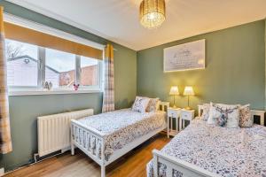 a bedroom with two beds and a window at 2 Bed in Lowick oc-c34008 in Lowick