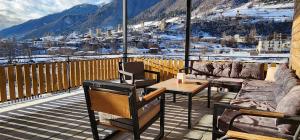 a patio with a table and chairs on a balcony at hotel "Riverside Mestia" in Mestia