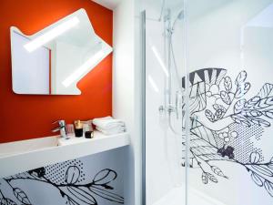 a bathroom with a shower and a sink at ibis budget Nuits Saint Georges in Nuits-Saint-Georges +39 photos