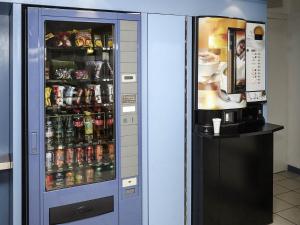 a vending machine filled with lots of drinks at ibis budget Nuits Saint Georges in Nuits-Saint-Georges