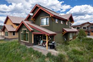 a green house with a red roof at 2002 Lupine Lane in Tabernash