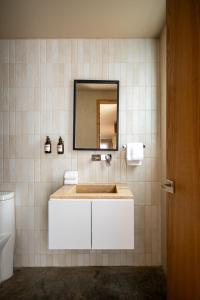 a bathroom with a white sink and a mirror at Hotel Oculto in Mexico City +40 photos