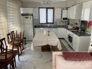 a kitchen with a table with a table cloth on it at Villa Efes in Hisarcık